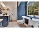 Stylish bathroom featuring a classic clawfoot tub, dark blue walls, and a modern sink vanity at 305 Postwood Dr, Fayetteville, GA 30215