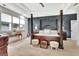 Stunning primary bedroom with tray ceiling, a wooden four-poster bed, and beautiful wall accents at 305 Postwood Dr, Fayetteville, GA 30215
