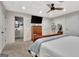 Finished bedroom with neutral carpet, wood bed and mounted television at 305 Postwood Dr, Fayetteville, GA 30215