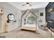 Bright bedroom featuring a unique canopy bed, white dresser, and a hanging macrame chair at 305 Postwood Dr, Fayetteville, GA 30215