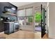 Close-up of a coffee bar featuring a small refrigerator and hardwood floors with view of back porch at 305 Postwood Dr, Fayetteville, GA 30215