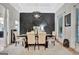 Elegant dining room with decorative wall accents, stylish lighting, and seating for six around a wood table at 305 Postwood Dr, Fayetteville, GA 30215