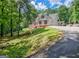 Spacious home with a sprawling driveway and lush green surroundings at 305 Postwood Dr, Fayetteville, GA 30215