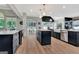 Open kitchen featuring a central island, stainless appliances, and eat-in dining area at 305 Postwood Dr, Fayetteville, GA 30215