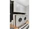 Efficient laundry room featuring a washer, dryer, and ample white cabinet space at 305 Postwood Dr, Fayetteville, GA 30215