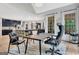 Open living area with a home office, hardwood floors, backyard views, and direct access to the kitchen at 305 Postwood Dr, Fayetteville, GA 30215