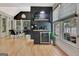 Bright living area featuring a coffee bar and hardwood floors with office and backyard views at 305 Postwood Dr, Fayetteville, GA 30215