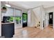 Bright living room features hardwood floors, black door, and window overlooking lush greenery at 305 Postwood Dr, Fayetteville, GA 30215