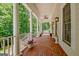 Covered porch with decorative pillars and potted plants, ideal for relaxation at 305 Postwood Dr, Fayetteville, GA 30215