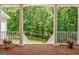 View from the porch with a serene, wooded backdrop and white railings at 305 Postwood Dr, Fayetteville, GA 30215
