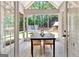 Bright sunroom featuring wood flooring, a dining table, and large windows with views of backyard at 305 Postwood Dr, Fayetteville, GA 30215