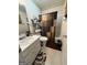 Standard bathroom featuring a functional vanity with tiled floors and a shower/tub with a curtain at 650 Flippen Rd, Stockbridge, GA 30281
