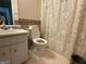 Cozy bathroom featuring a classic vanity with tiled floors and a shower/tub with a curtain at 650 Flippen Rd, Stockbridge, GA 30281