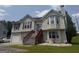 Charming two-story home boasts a well-maintained lawn, front-facing garage, and inviting front porch with decorative door and windows at 650 Flippen Rd, Stockbridge, GA 30281