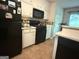 Functional kitchen offering white cabinets and dark appliances with a view into the backyard at 650 Flippen Rd, Stockbridge, GA 30281