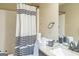 Full bathroom features a shower/tub combo with a striped curtain at 115 Glen Echo Dr., Covington, GA 30016