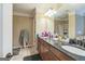 Bathroom features a double sink vanity with dark countertops and a large mirror at 115 Glen Echo Dr., Covington, GA 30016