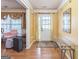 Inviting foyer featuring hardwood floors, neutral walls, and a decorative mirror, creating a warm and welcoming entrance at 115 Glen Echo Dr., Covington, GA 30016