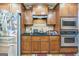 Well-equipped kitchen with stainless steel appliances, wood cabinetry, and a functional layout, great for meal preparation at 115 Glen Echo Dr., Covington, GA 30016