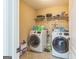 Well-equipped laundry room featuring a modern washer and dryer set and ample shelving at 115 Glen Echo Dr., Covington, GA 30016