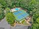 Aerial view of community amenities including a pool, tennis courts, playground, and ample parking surrounded by trees at 2010 Pearwood Path, Roswell, GA 30076