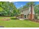 Spacious backyard with well-maintained lawn, patio area, and mature trees offering shade and privacy at 2010 Pearwood Path, Roswell, GA 30076