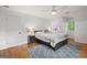 Serene bedroom featuring a comfortable bed, nightstands, wood floors, and a geometric patterned rug at 2010 Pearwood Path, Roswell, GA 30076