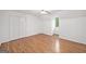 A bright bedroom with hardwood floors, a ceiling fan and a window with green views at 2010 Pearwood Path, Roswell, GA 30076