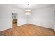 Spacious formal dining room with beautiful hardwood floors, white trim, and elegant chandelier at 2010 Pearwood Path, Roswell, GA 30076