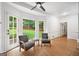 Bright living room with hardwood floors, white walls, and natural light streaming through the large window at 2010 Pearwood Path, Roswell, GA 30076