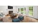 Cozy living room with fireplace, plush seating, and a door to backyard at 2010 Pearwood Path, Roswell, GA 30076