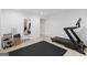Basement home gym area with treadmill, weights, mirror, and protective floor mat at 2885 Laurel Green Ct, Roswell, GA 30076