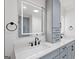 Contemporary bathroom featuring quartz countertop, gray cabinets, and lighted mirror at 2885 Laurel Green Ct, Roswell, GA 30076