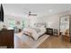 Spacious primary bedroom with hardwood floors, ceiling fan, and windows for natural light at 2885 Laurel Green Ct, Roswell, GA 30076