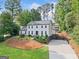 Stunning traditional home with a beautiful lawn and a long driveway to the two-car garage at 2885 Laurel Green Ct, Roswell, GA 30076