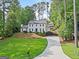 Inviting traditional home featuring a well-manicured lawn and a long driveway at 2885 Laurel Green Ct, Roswell, GA 30076