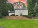 Charming two-story home with bright exterior lighting and a lush green lawn at 2885 Laurel Green Ct, Roswell, GA 30076