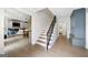 Hallway featuring hardwood floors, black metal stair railing, and views to the living room and bathroom at 2885 Laurel Green Ct, Roswell, GA 30076