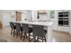 Kitchen island with white marble countertop, seating for four, and stainless steel appliances at 2885 Laurel Green Ct, Roswell, GA 30076