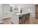 Modern kitchen island with seating for four, a marble countertop, and stainless steel appliances at 2885 Laurel Green Ct, Roswell, GA 30076