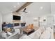 Open-concept living room with a stone fireplace, wood beams, and a sliding barn door at 2885 Laurel Green Ct, Roswell, GA 30076