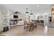 Open-concept living space with a dining area, living room, kitchen, and a fireplace with a TV above at 2885 Laurel Green Ct, Roswell, GA 30076