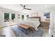 Spacious bedroom with French doors, natural light, ceiling fan, and rustic bed at 2885 Laurel Green Ct, Roswell, GA 30076