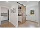 Walk-in pantry featuring custom cabinets and a sliding barn door at 2885 Laurel Green Ct, Roswell, GA 30076
