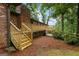 Inviting back deck with steps offers a lovely outdoor space and complements the brick exterior of the home at 1124 Ponderosa Park Dr, Forest Park, GA 30297