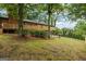 Home with a large wooden deck and a beautiful, shaded backyard at 1124 Ponderosa Park Dr, Forest Park, GA 30297