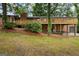 Home with a large wooden deck, brick facade, and a well-maintained lawn at 1124 Ponderosa Park Dr, Forest Park, GA 30297