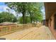 Spacious wooden deck with railing and brick exterior details at 1124 Ponderosa Park Dr, Forest Park, GA 30297