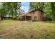 Brick home with a spacious wooden deck overlooking the lush backyard at 1124 Ponderosa Park Dr, Forest Park, GA 30297