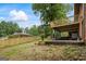 View of the backyard showing the wood fence line, patio under the deck, and grassy area at 1124 Ponderosa Park Dr, Forest Park, GA 30297